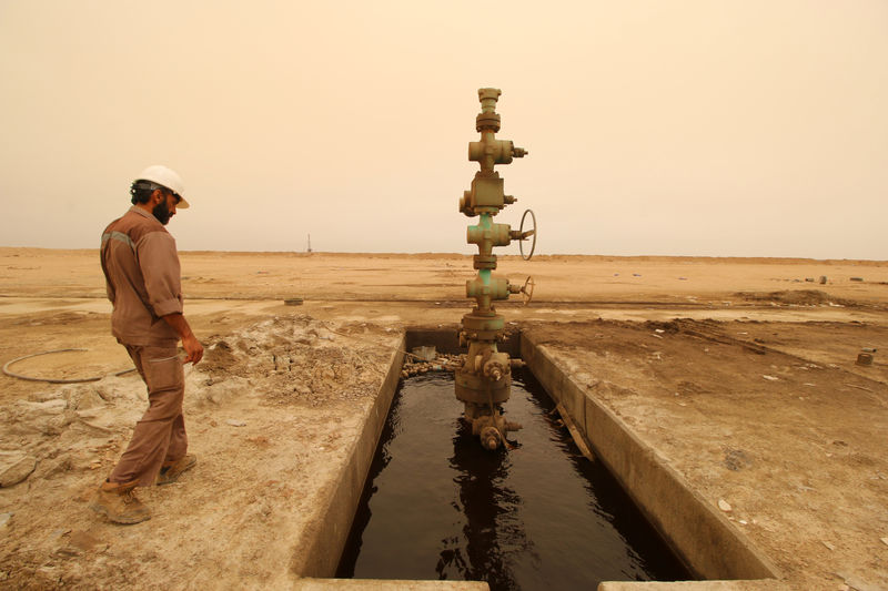 A worker walks past the oil well at the Sindbad oil field near the Iraqi-Iranian border in Basra, Iraq April 23, 2018. Picture taken April 23, 2018.  REUTERS/Essam Al-Sudani